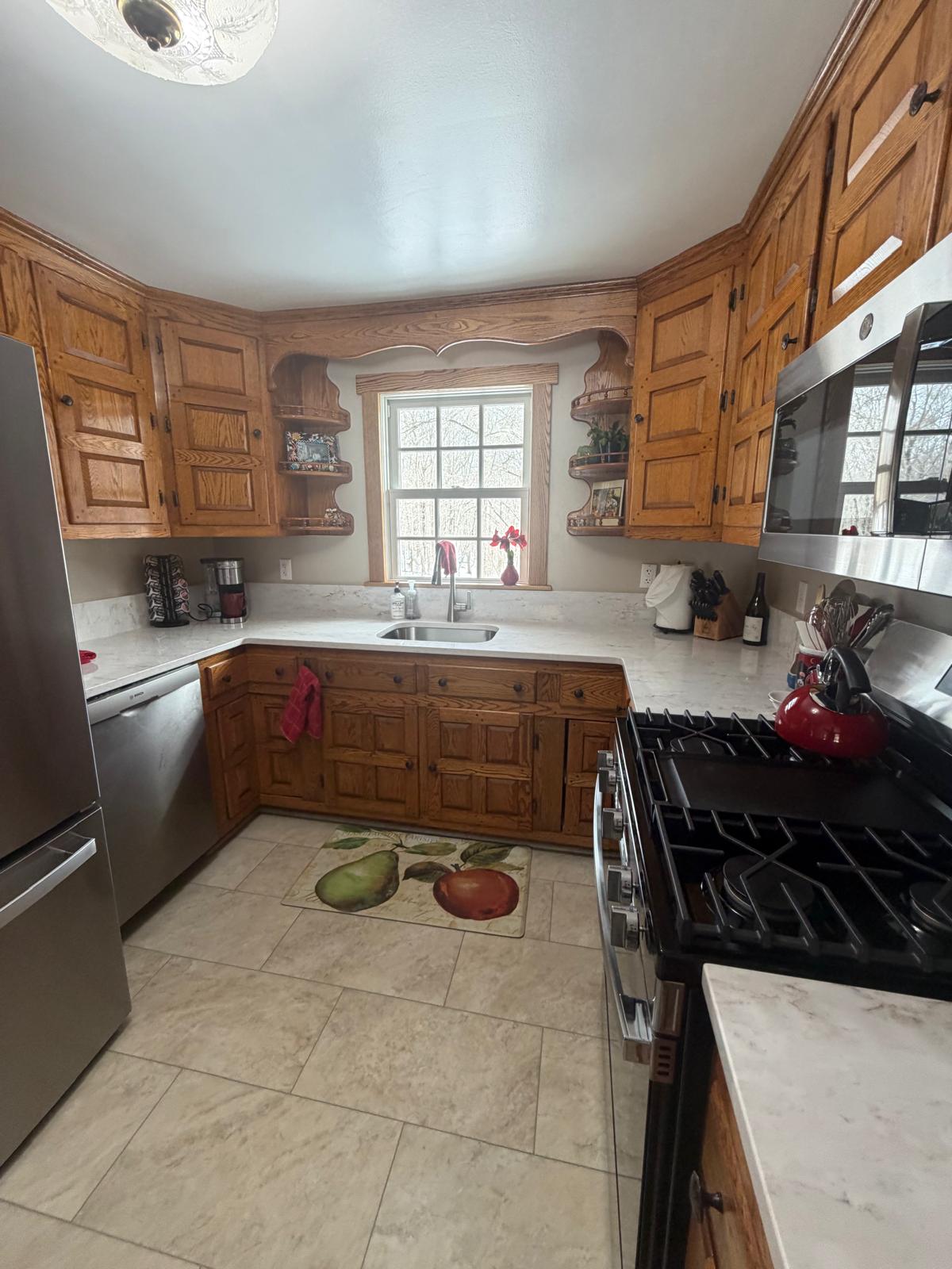 Wood-cabinet kitchen with counters cleared and sanitized