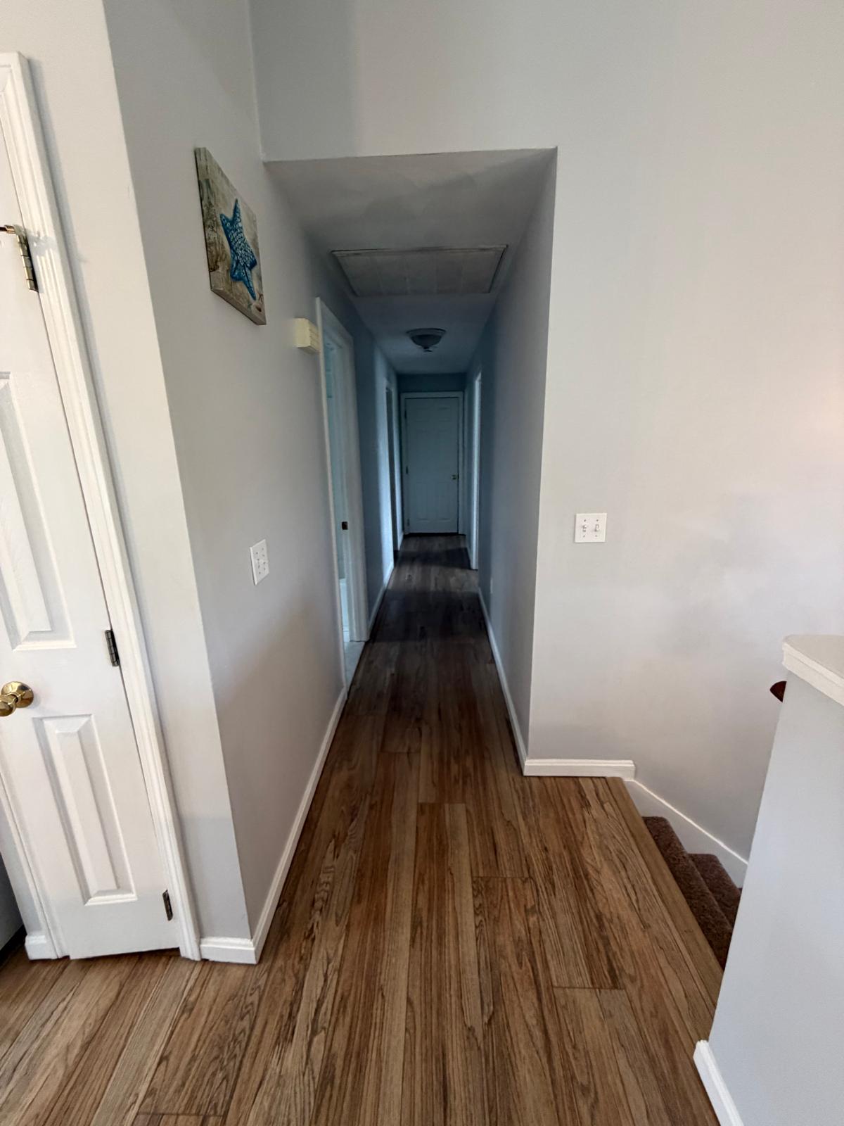 Hallway with wood-look floors vacuumed and mopped