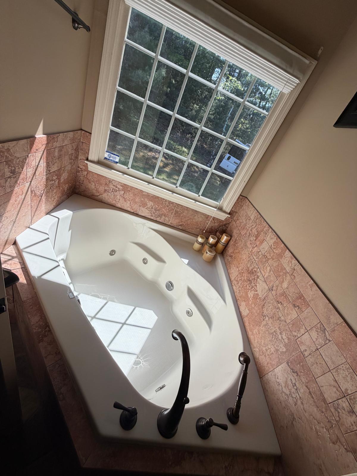 Corner jacuzzi tub and tile surround scrubbed and polished