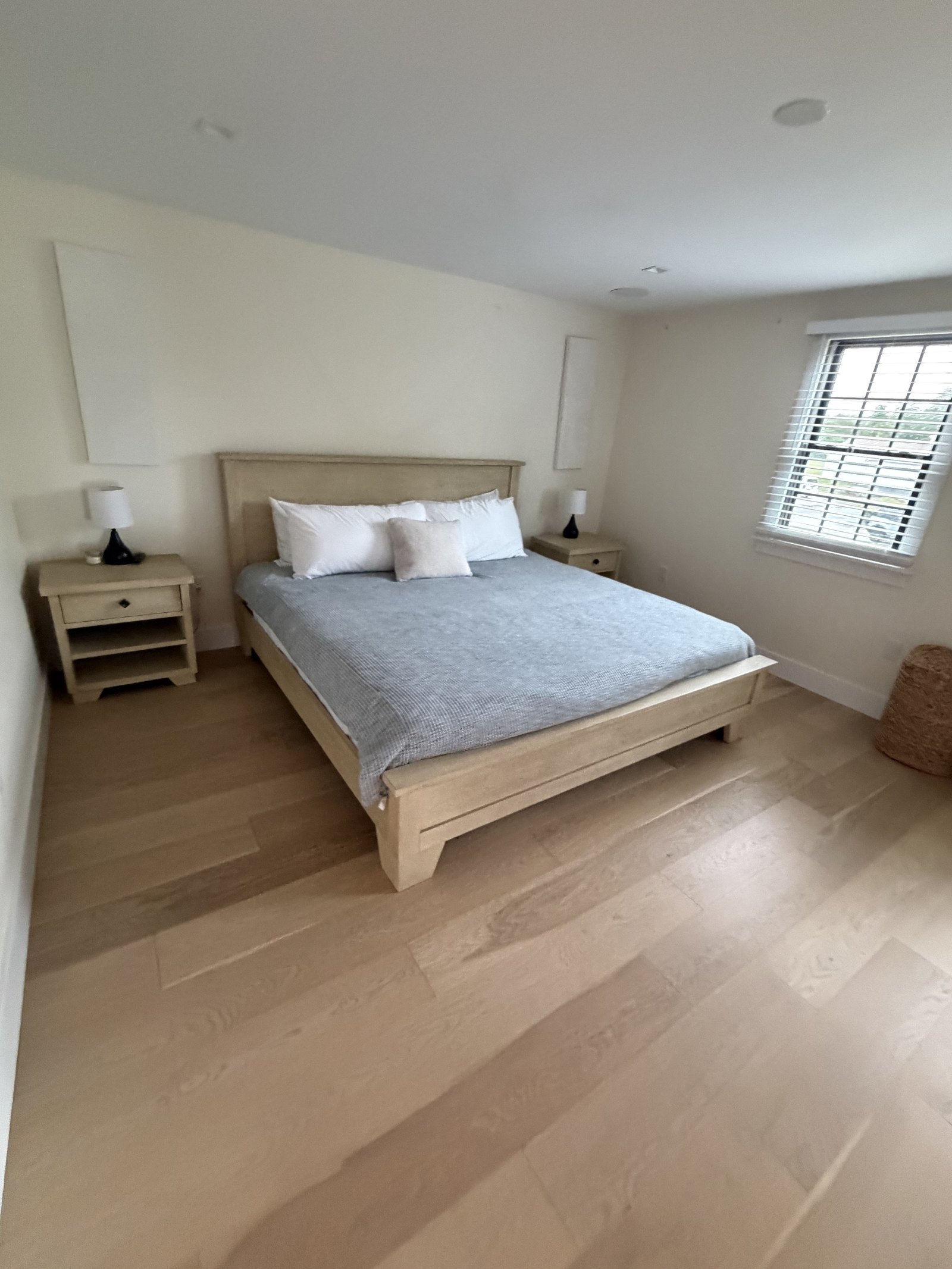 Freshly made bed and dusted bedroom after a residential cleaning