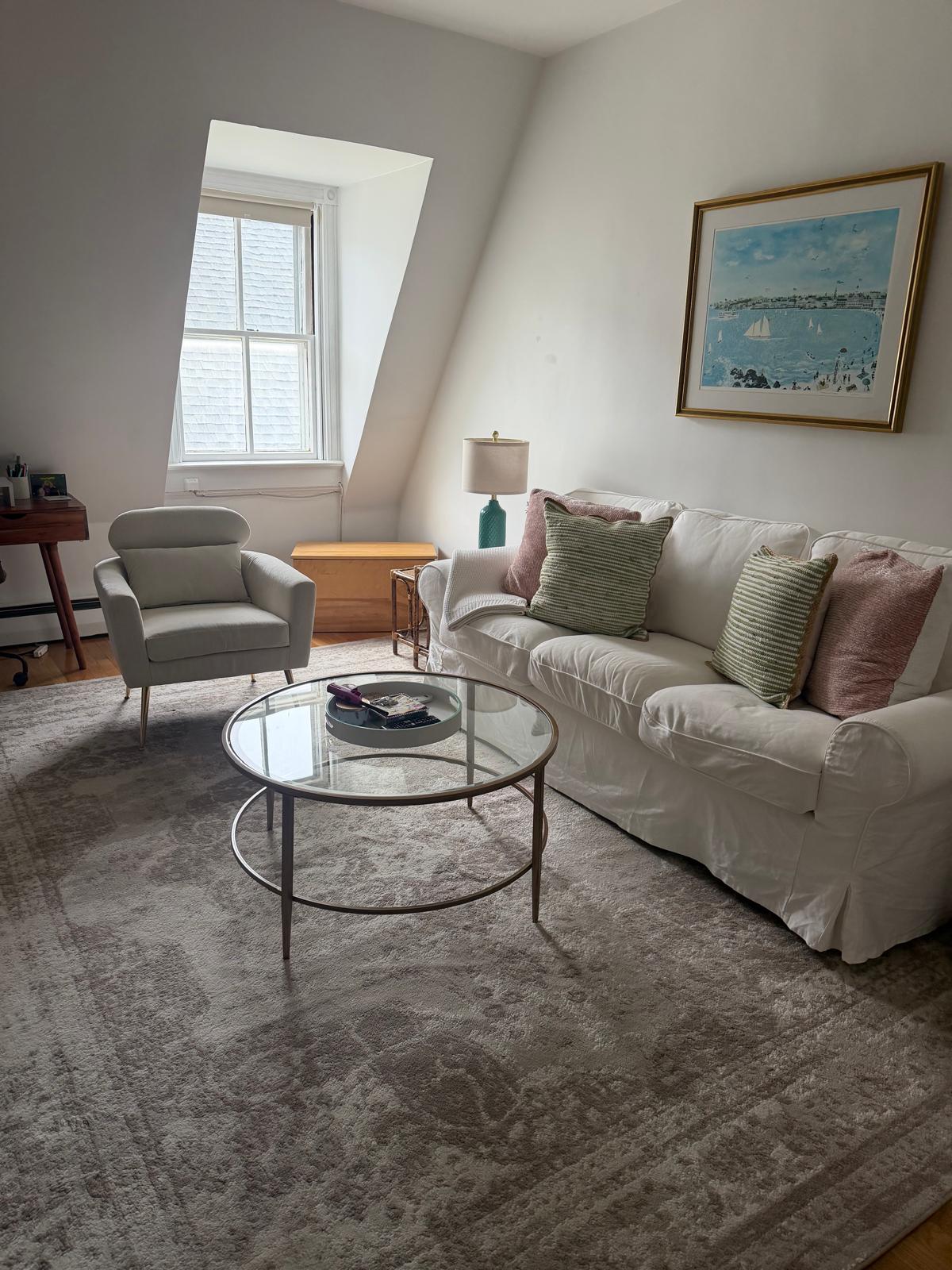 Cozy sitting room with sofa and glass coffee table after cleaning