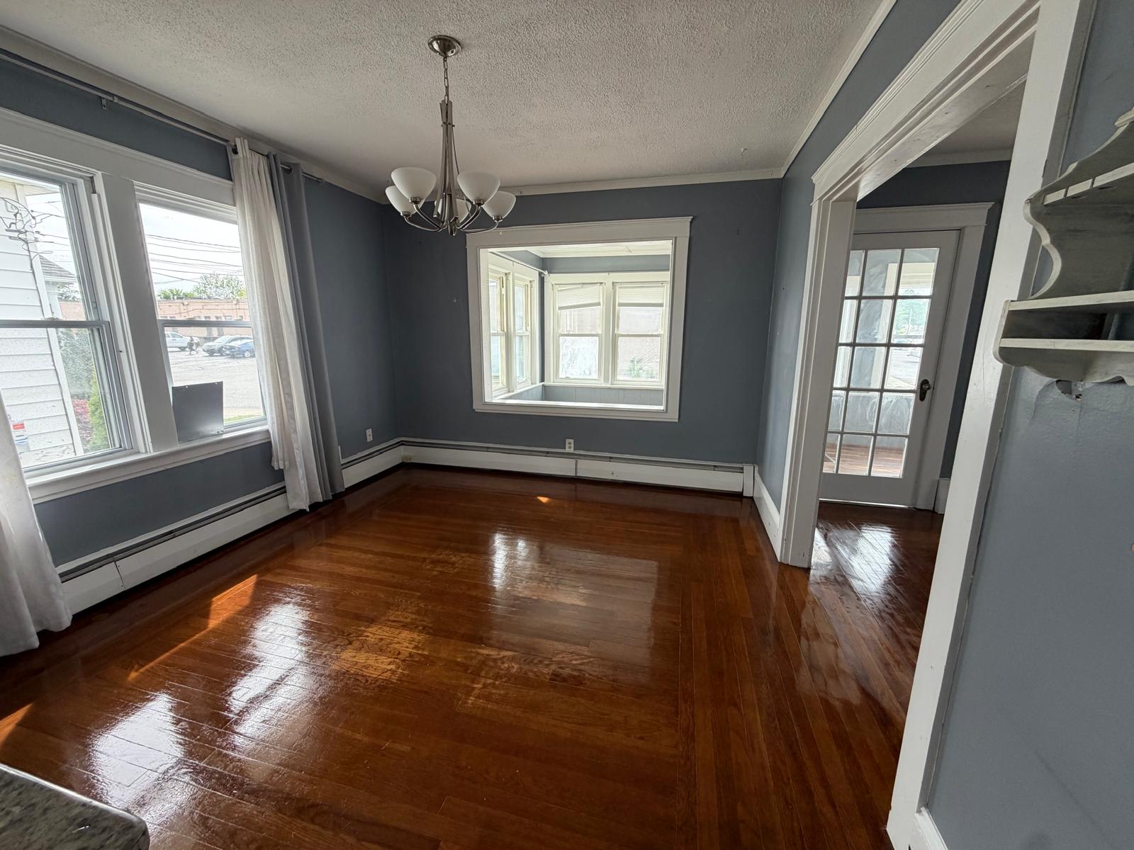 Dining room with gleaming hardwood floors after a move-out cleaning