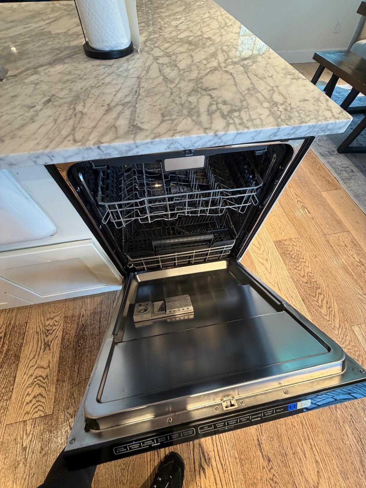 Dishwasher interior cleaned and sanitized during a deep kitchen clean