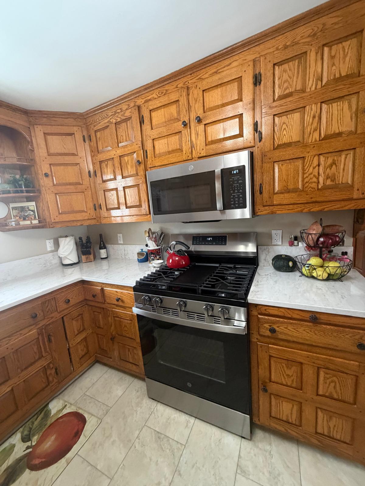 Gas range and wood cabinets gleaming after a deep kitchen clean
