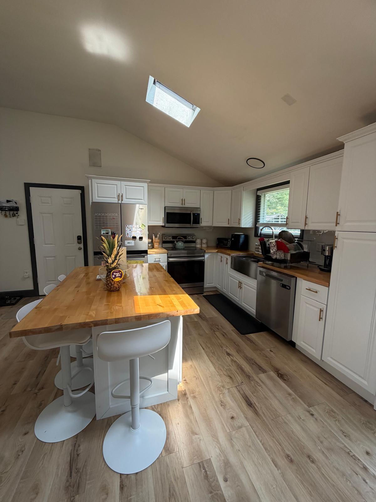 Kitchen with butcher-block island and counters wiped down