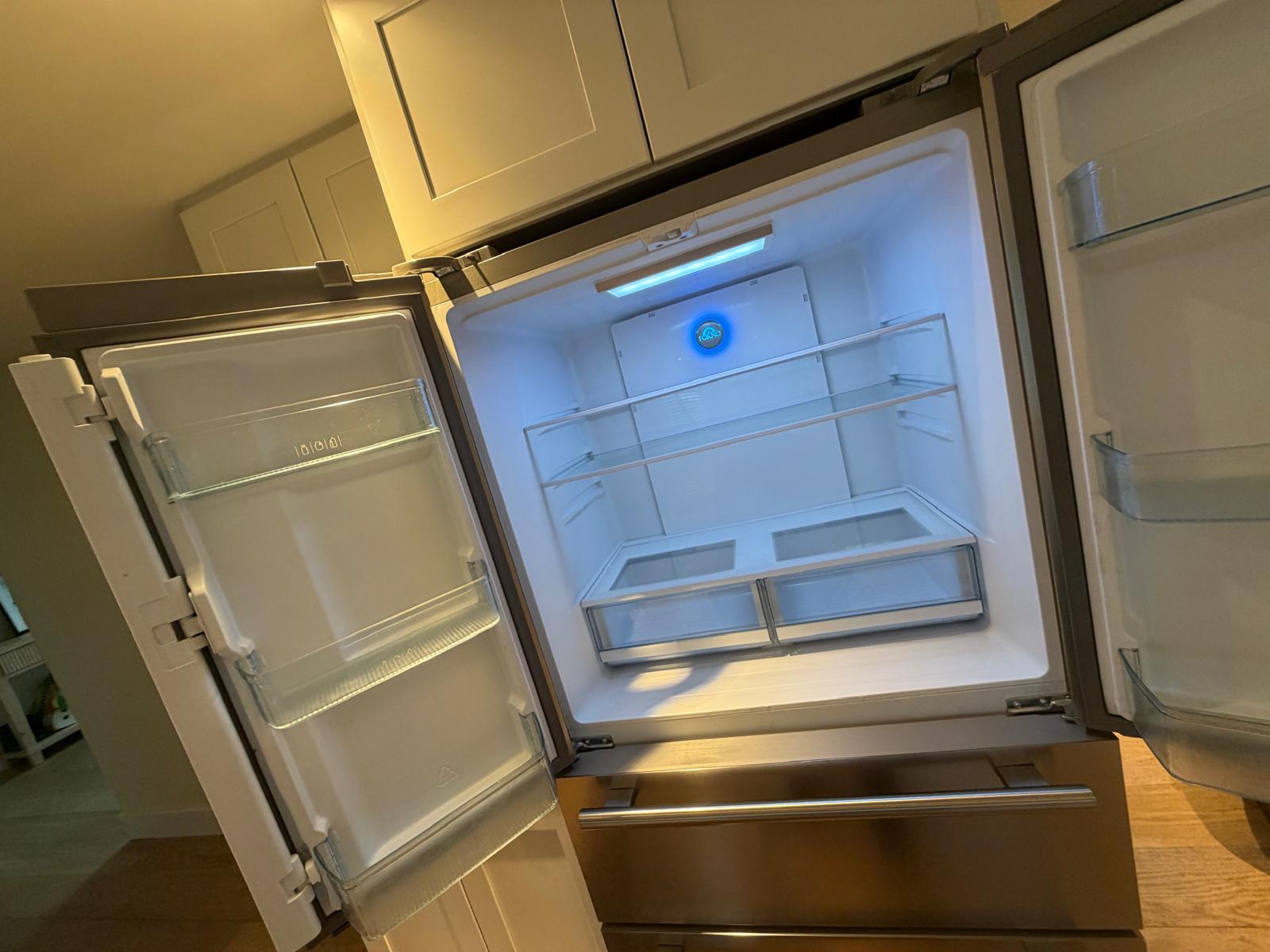 Refrigerator interior emptied and sanitized during a deep clean