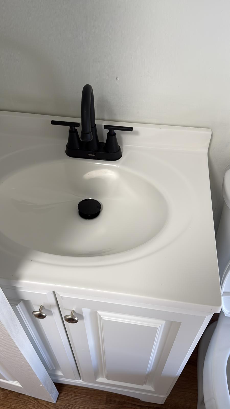 Bathroom vanity with black fixtures wiped spotless