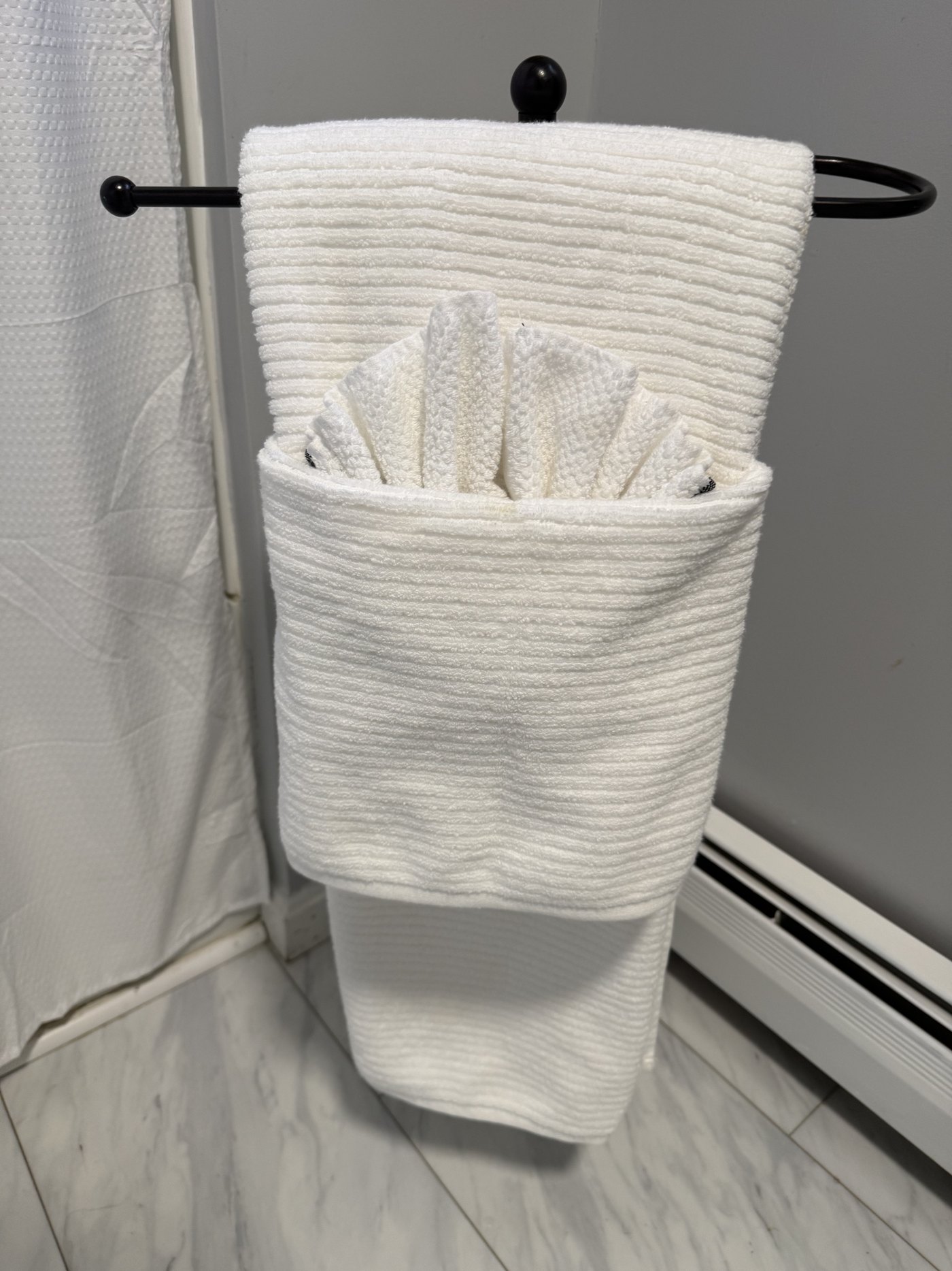 Bathroom towels folded in a decorative fan after a detail clean