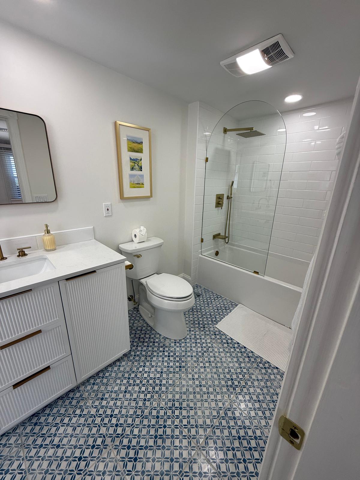 Bathroom with glass shower and patterned tile floor deep cleaned