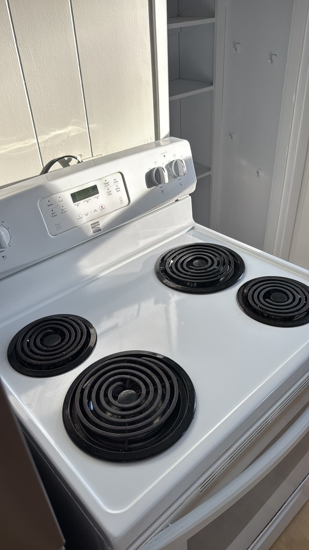 Degreased white electric stovetop after a deep kitchen clean
