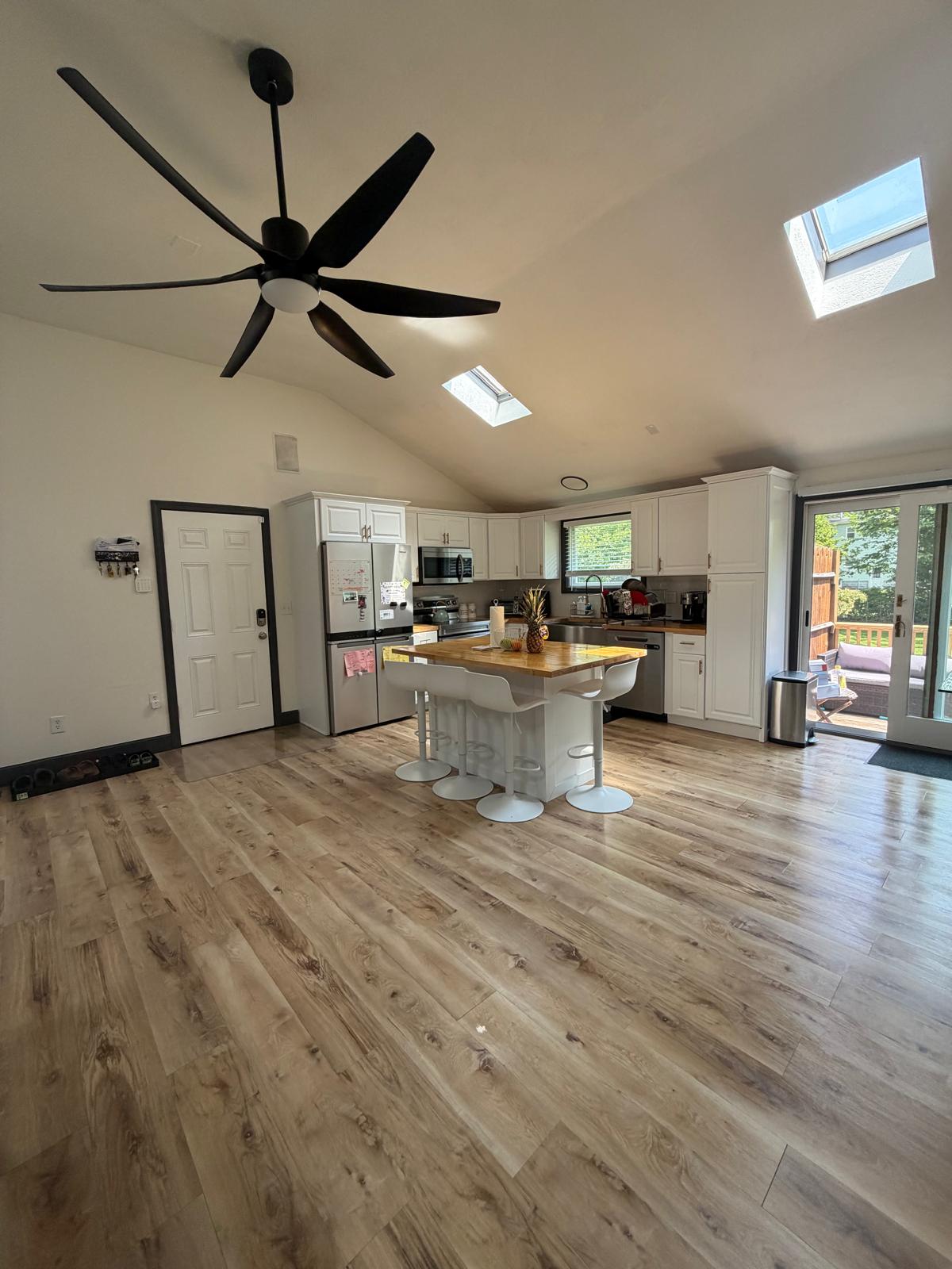 Open kitchen and living area with floors shining after cleaning