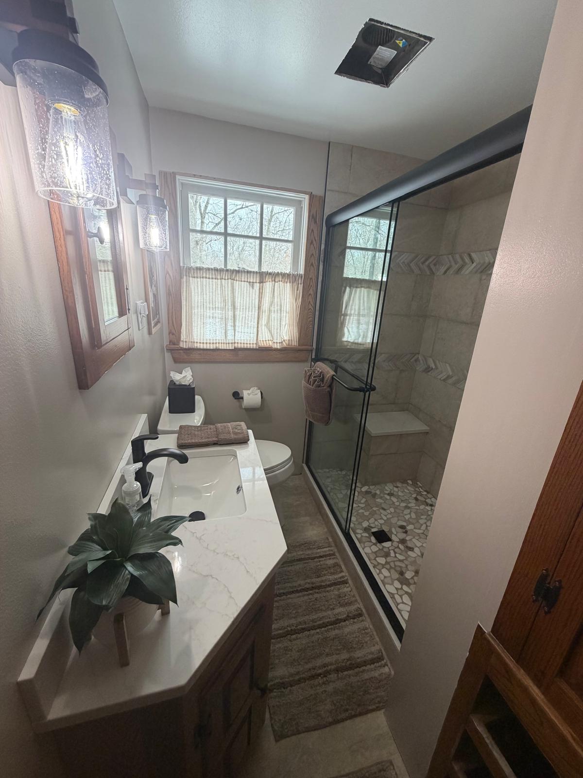 Bathroom with walk-in pebble-floor shower deep cleaned
