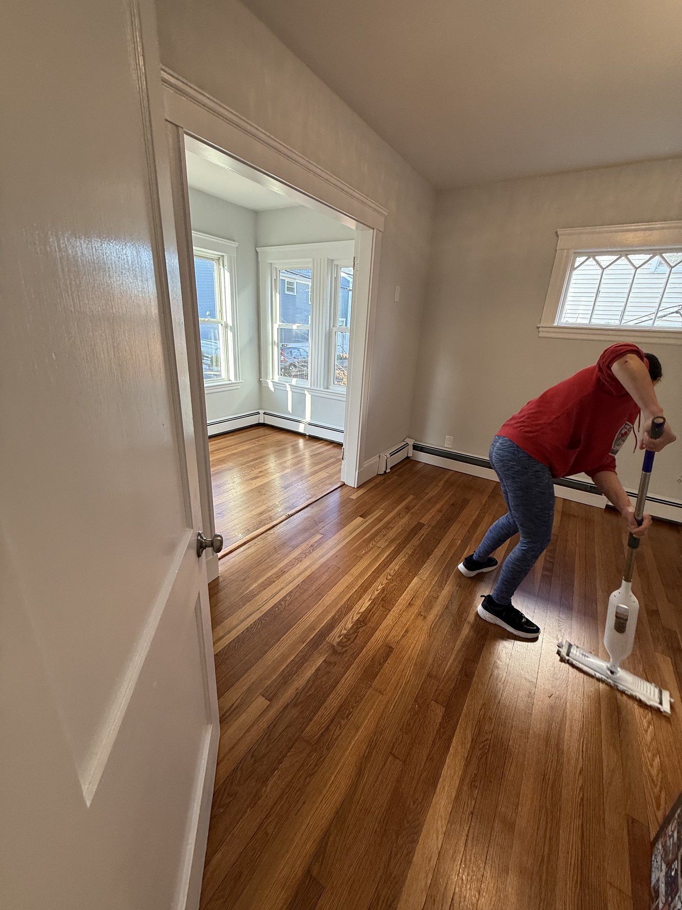 Gomes Cleaning team member mopping hardwood floors